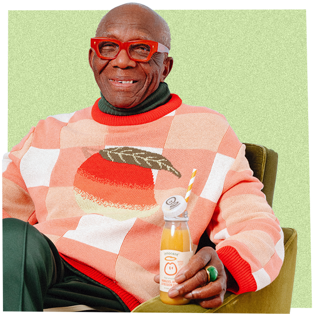 man wearing a big knitwear jumper and holding an innocent smoothie