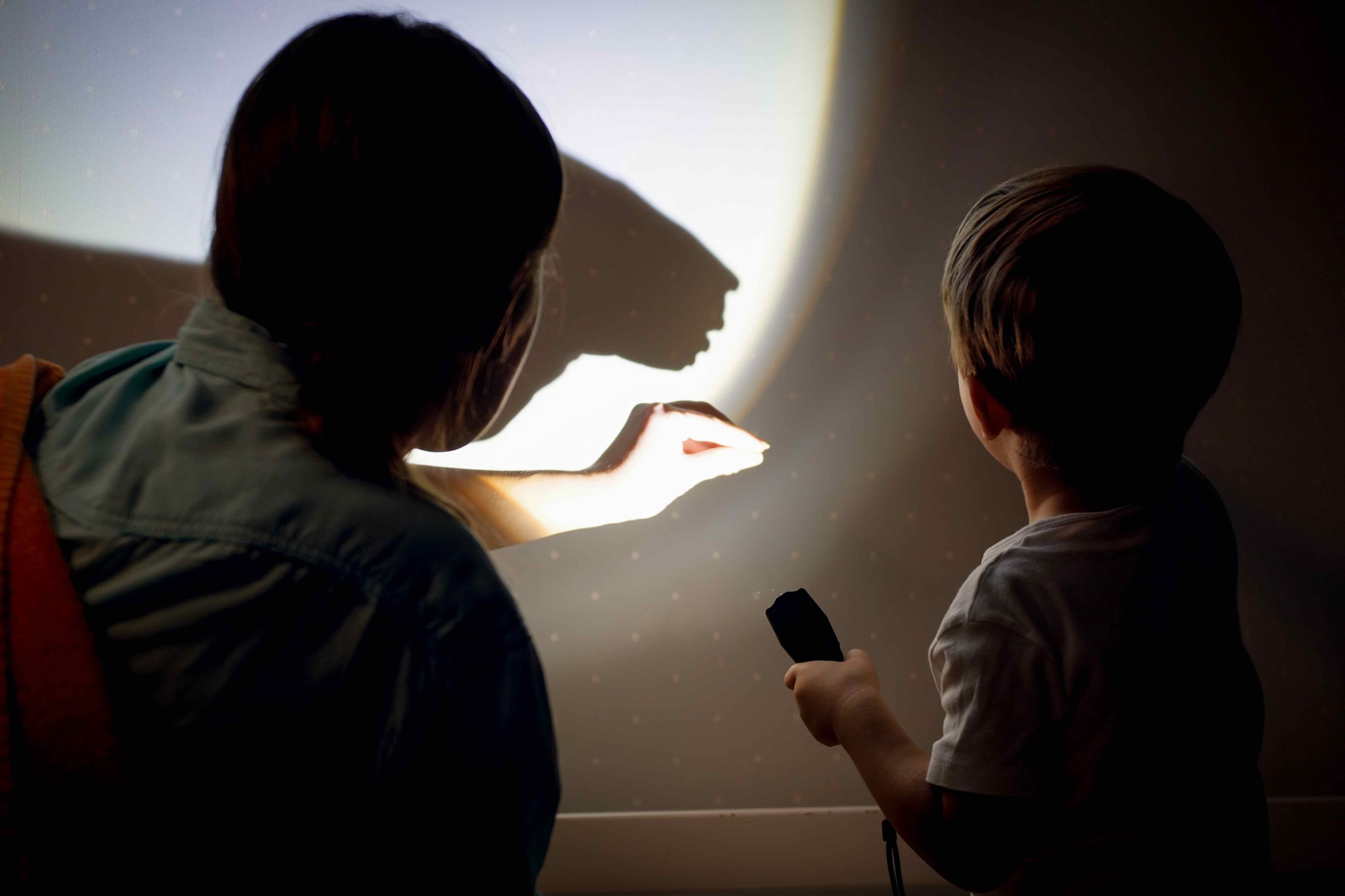 InnocentDrinks, person and child shadow puppeting